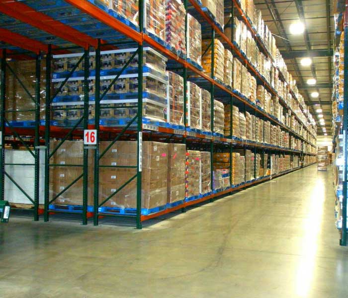 View of aisle in a distribution warehouse with double deep pallet racking