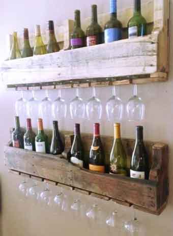 Pieces of pallet racking repurposed to make a shelf that holds wine, and wine glasses hang upside down underneath