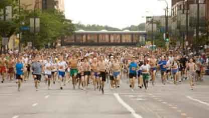 A Group of runners make their way through a city