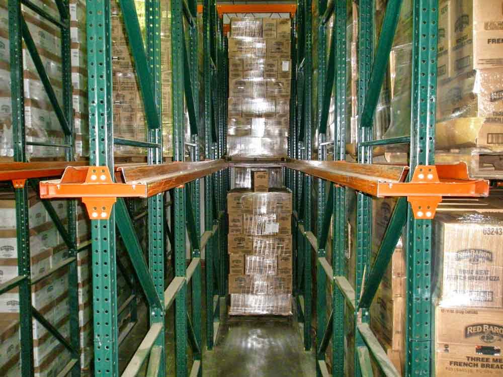 An aisle is filled part of the way with materials in a drive in pallet racking system