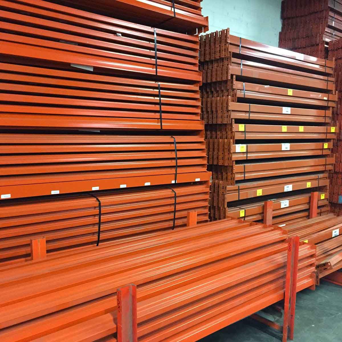 Pallet rack beams sit on top of eachother in a warehouse