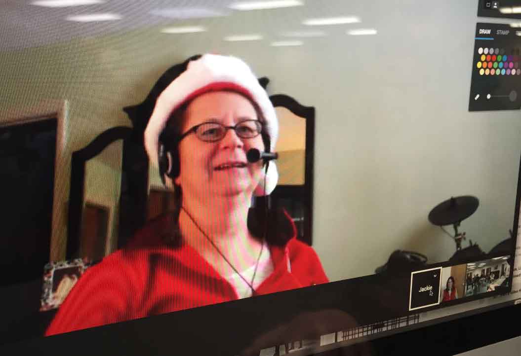 AKMHS Employee Jackie smiles and wears a santa hat