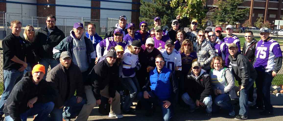 AK Employees smile at the camera wearing their viking's gear