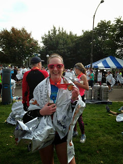 Jillian Baird smiles and holds a metal as she looks at the camera.