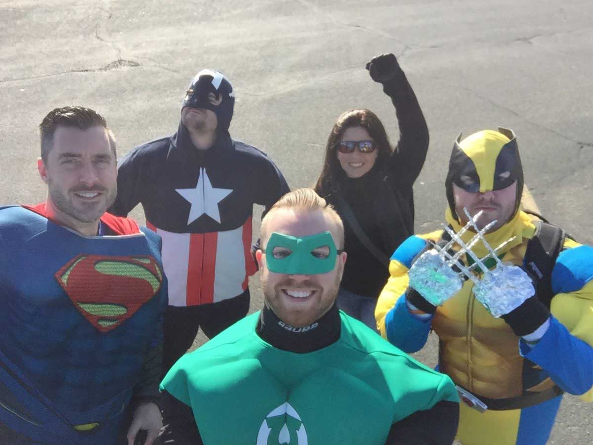 ak team members dressed up as super heros