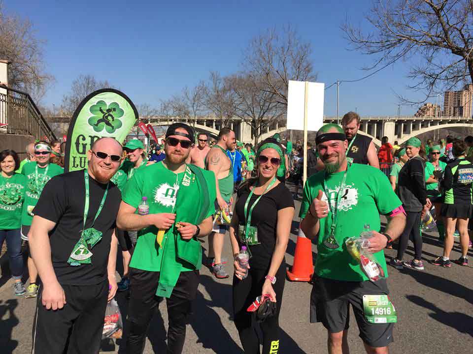 AK Employees Smile while wearing green before the Get Lucky 7K