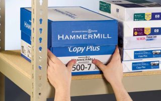 hands grabbing a box off of heavy duty shelving