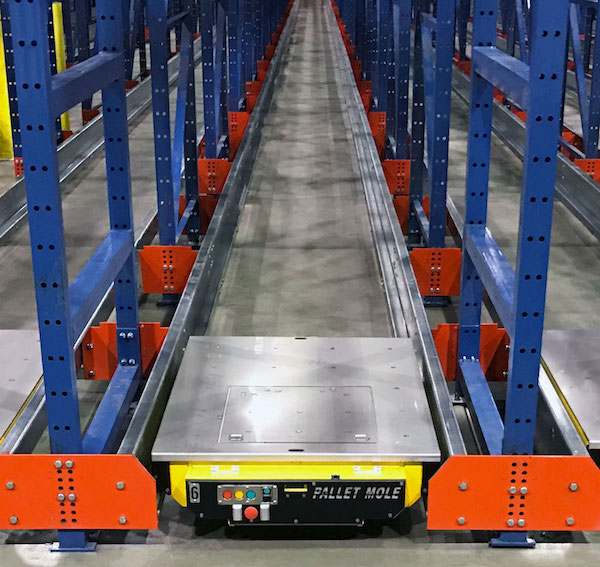 View of an empty pallet rack bay with a Frazier semi automated pallet mole.