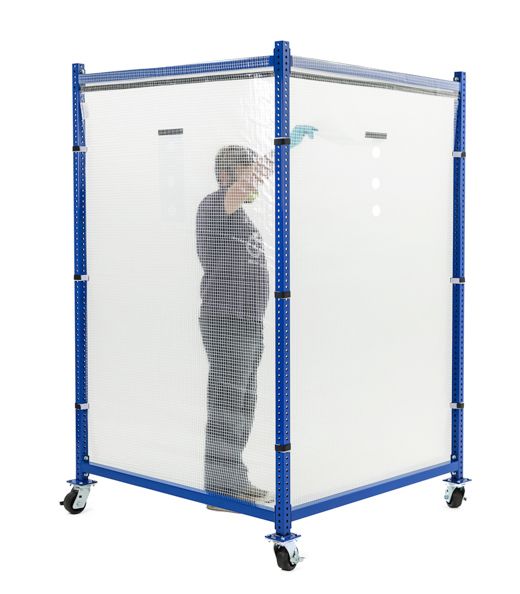 Man standing inside of a medical testing booth