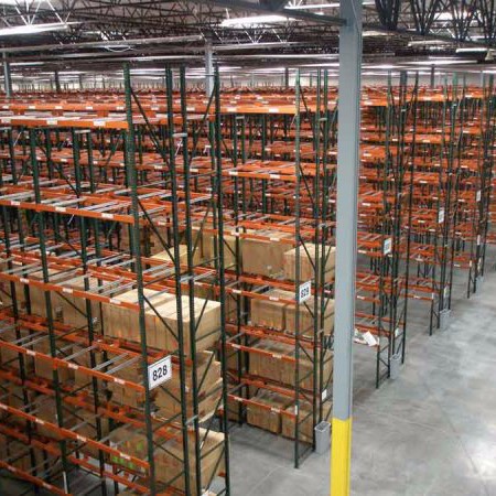 Multiple row pallet rack system within a distribution warehouse with building columns in the aisle.