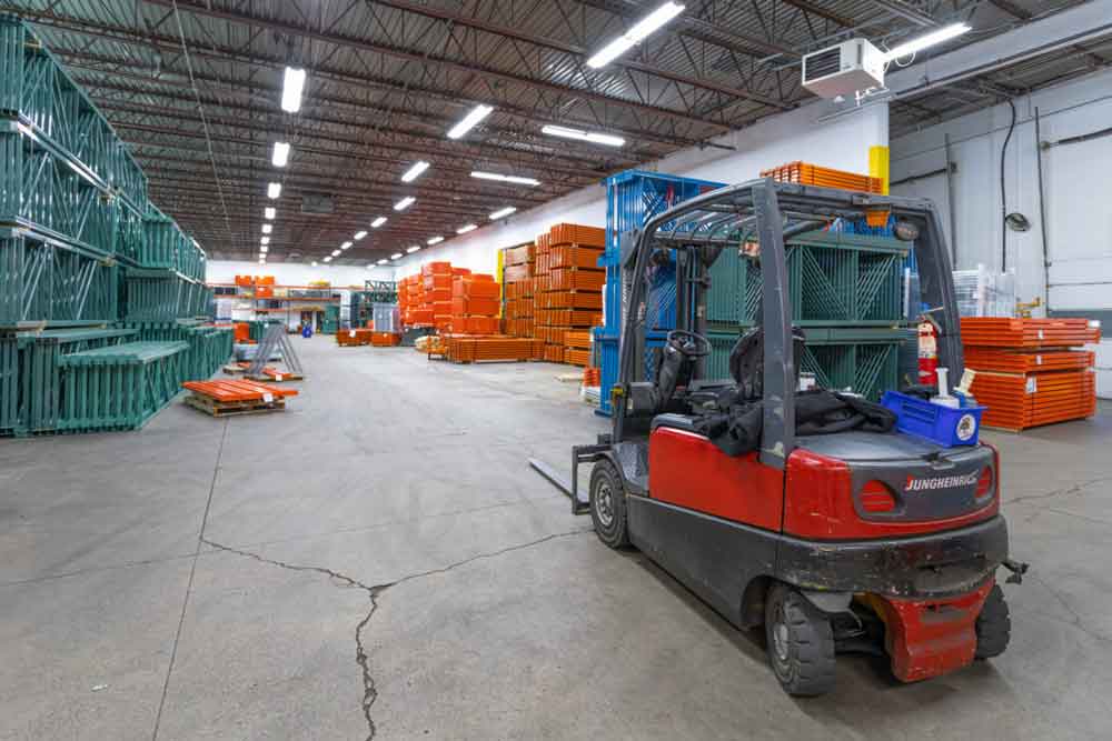Warehouse shipping specialists utilizing forklifts to prepare shipments.