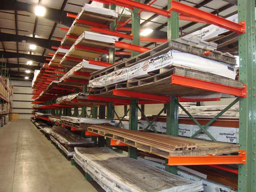 Row of cantilever storage rack system holding wood pallets