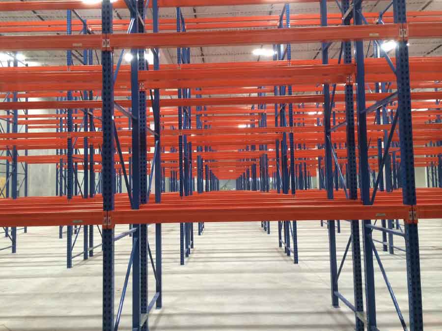 Rows of blue and orange pallet racking sit empty in the miners’ grocery store warehouse