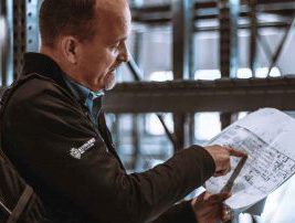 AK Material Handling Systems employee Brian Koski Looking at warehouse layout design he created inside the warehouse