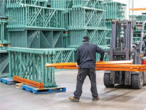 Warehouse team member preparing a pallet rack shipment for delivery