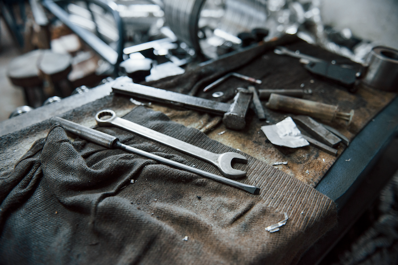 work tools on a dirty table in a garage