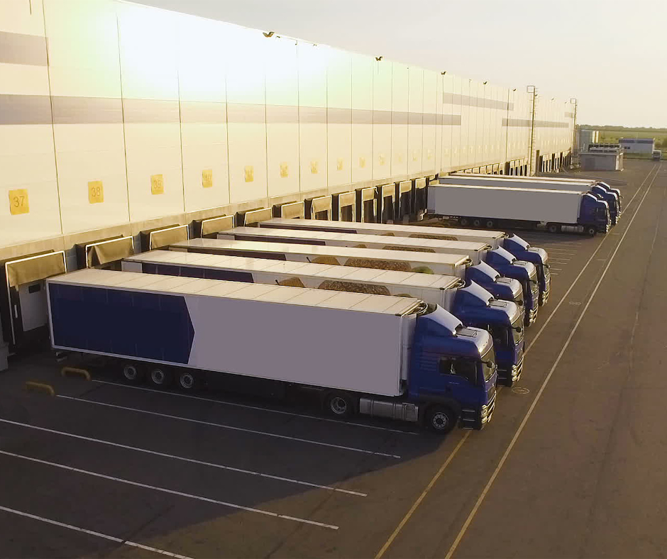 Rows of semi's backed up to warehouse before getting loaded